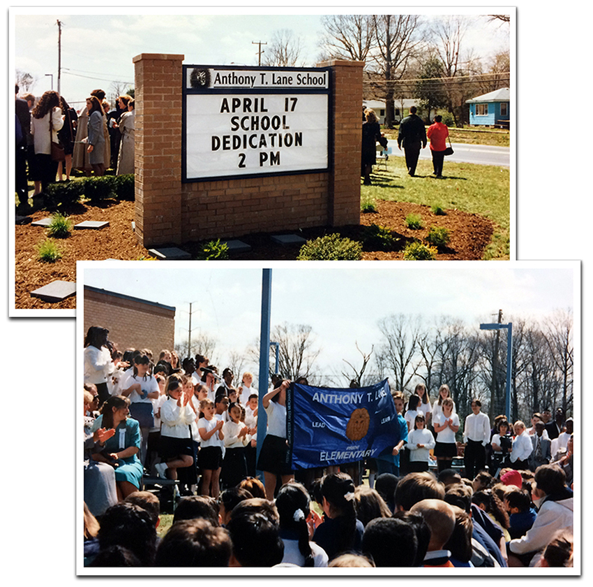 Two color photographs, one above the other, taken on the day of dedication. The top photograph shows the school sign in front of the building. It is a large, brick bordered sign with a white placard in the center. The sign gives the name of the school and the date of dedication. Adults can be seen milling about in the background. Beneath this photograph is another picture from the dedication. In the background, the school chorus stands on risers. They are clapping their hands. In the mid-ground a group of students is holding up a large blue flag or banner. The banner has the words Anthony T. Lane Elementary printed on it in white, and a picture of a lion’s head, in brown or gold, in the center. A large crowd is pictured in the foreground watching the festivities.  